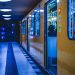 A yellow train at a Berlin subway station, illuminated at night, showcasing metro life.